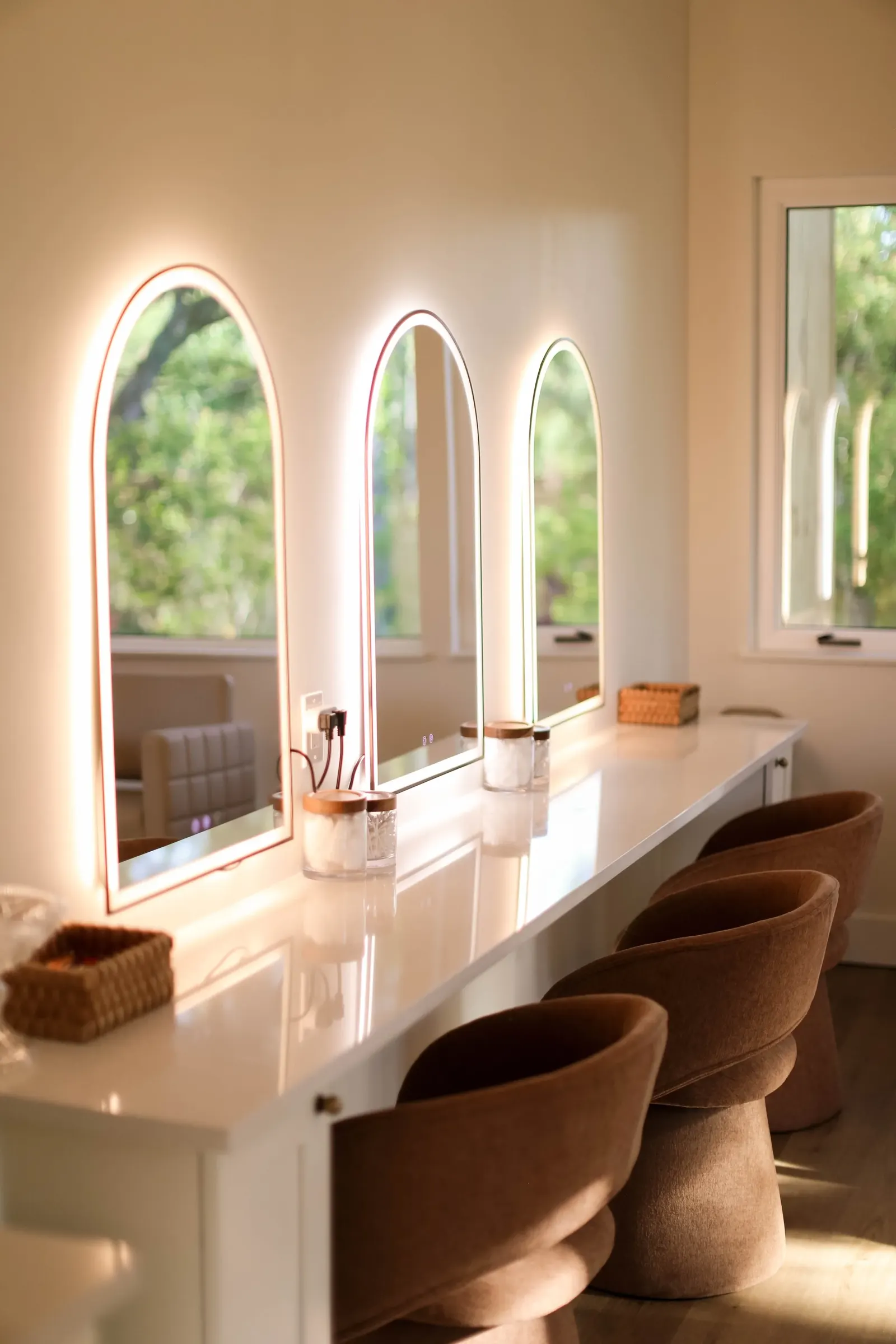 Arched light-up mirrors in a remodeled couple suite